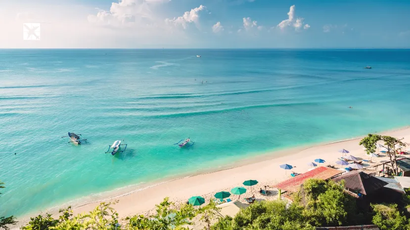 Tropical blue ocean, sandy beach and boats in Indonesia, Bali