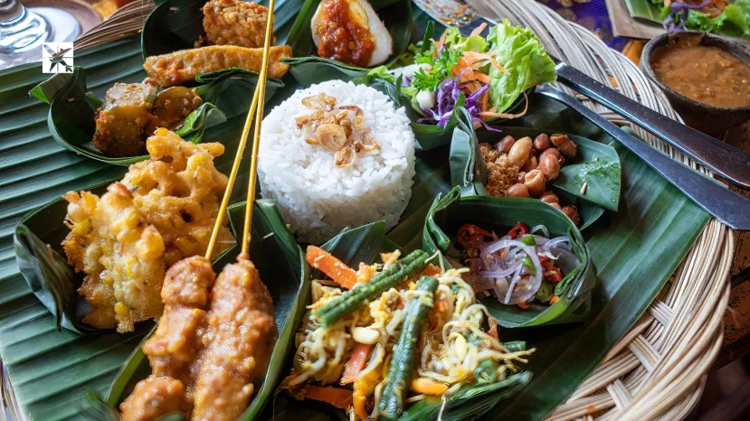 Indonesian dinner consisting of small dishes including satay, rice, tempeh and salads