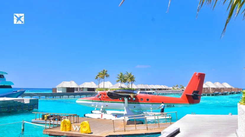 White and Red Seaplane on Maldives beach